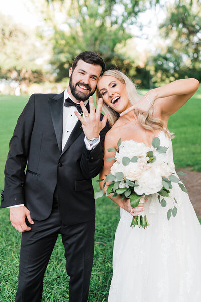 Bride and groom beaming as they show off their wedding rings, celebrating a joyful and relaxed wedding day planned in Austin, Texas.