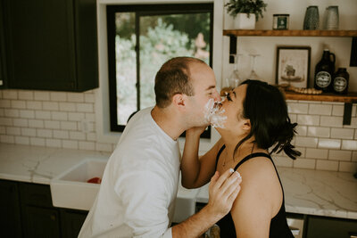 Couple kissing after a food fight.