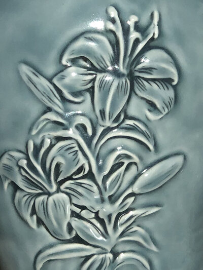 liz-allen-urn-detail-closeup-hand-carved-lily-with-blue-glaze