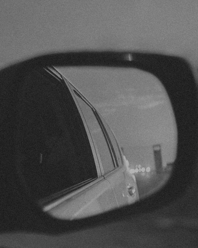 A car’s side mirror reflecting the road behind, symbolizing self-reflection and the awakening explored in the “I Am Being Treated Terribly” Learning Path from CPTSD Medicine.