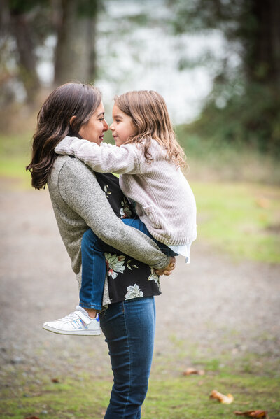 A mom holding a small girl