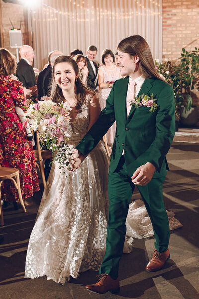 A couple walks down the aisle at their wedding at The Arbory in Chicago