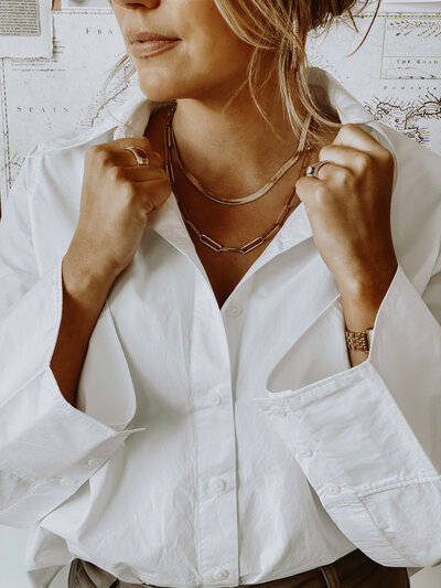 Woman wearing white shirt in front of mood board