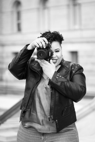 A black photographer poses in her Alexandria, VA photography studio