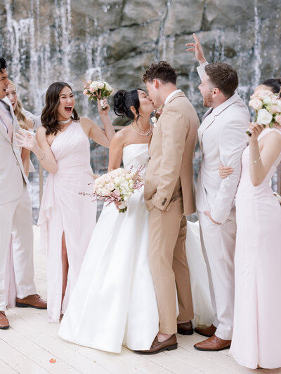 A groom kissing a bride on the cheek
