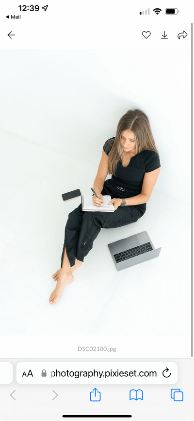 kylie writing, sitting on floor, laptop, phone, lagree