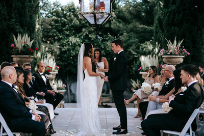 Bride and groom look into eachothers eyes as they walk