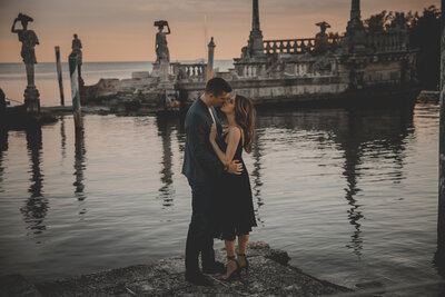 couple kissing in front of water