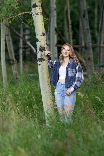 high school senior girl sitting in a grassy field