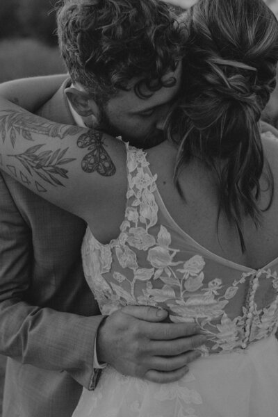 bride & groom joyfully smiling at the camera