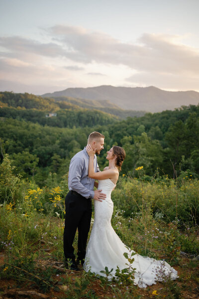 elopement locations in Gatlinburg for a Smoky Mountain elopement with bride adn groom embracing on a foothill