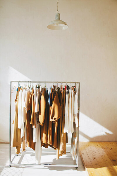 brown coats and clothing on a rack