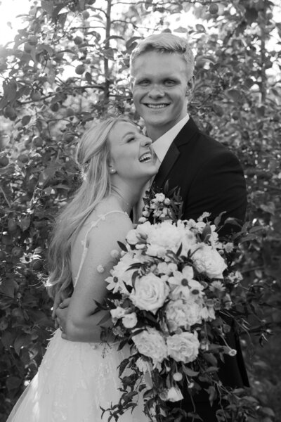 photo of a bride and groom laughing and embracing each other taken by a Milwaukee lifestyle photographer
