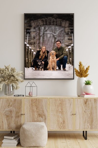 Framed artwork of a family with two dogs