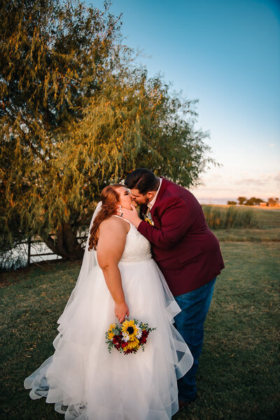 bride and groom first kiss on wedding day