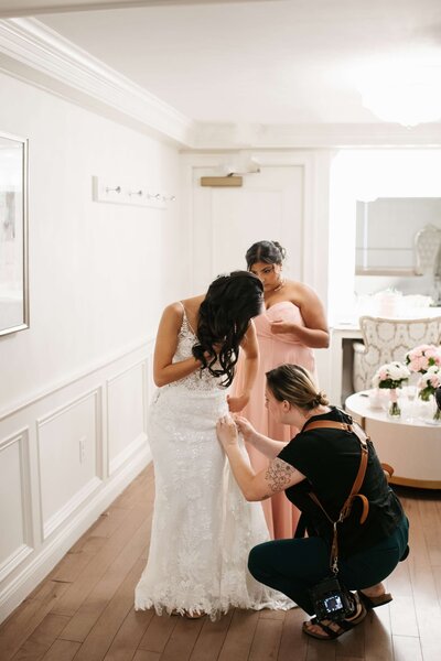 Danielle Littles Photography helping bride with her dress