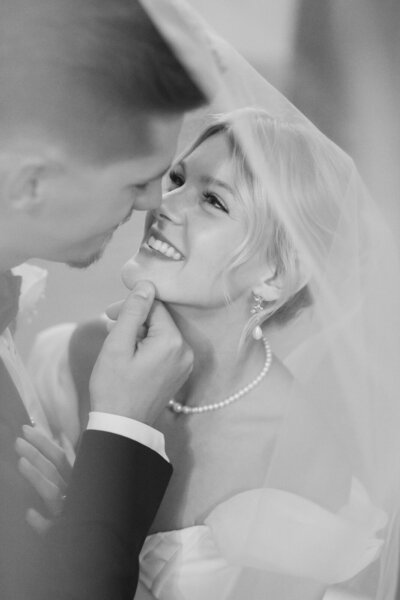 Romantic wedding portrait of the bride and groom snuggling at The Mason in Dallas.
