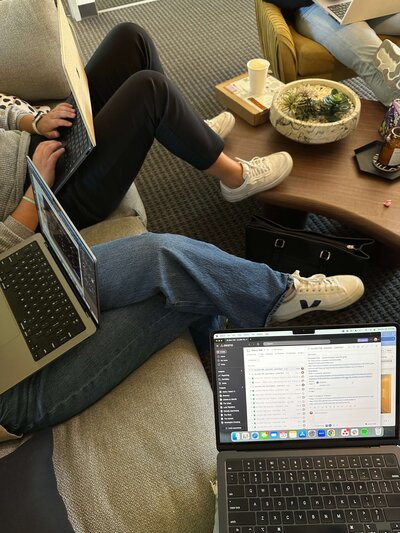 group of girls working together on their laptops