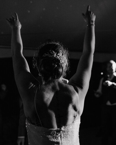 Happy bride on her wedding day, dancing at her Washington wedding captured by a wedding candid photographer