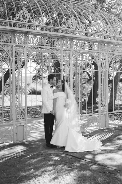 Bride and groom under ceremony arch at Ma Maison