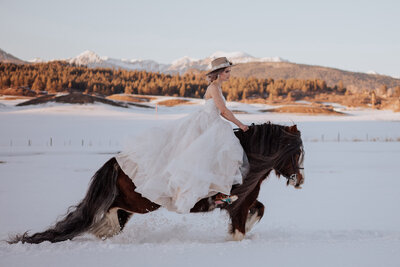bride rides on horse in snow
