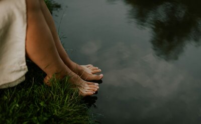 woman with her feet in calm water