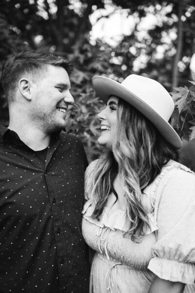 man and woman smiling while looking at each other