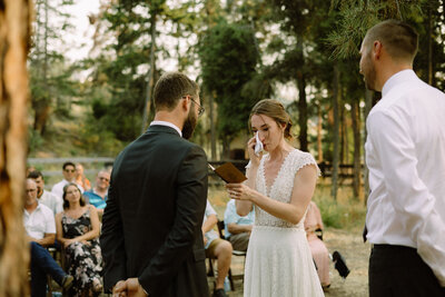 couple sharing vows in their backyard wedding in kelowna