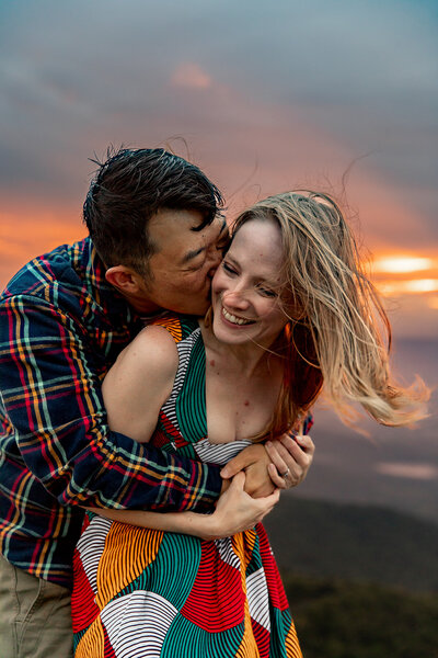 man kissing womans cheek