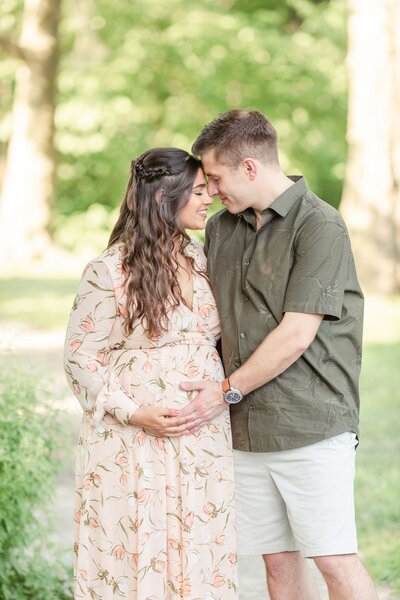 Couple touching foreheads maternity session