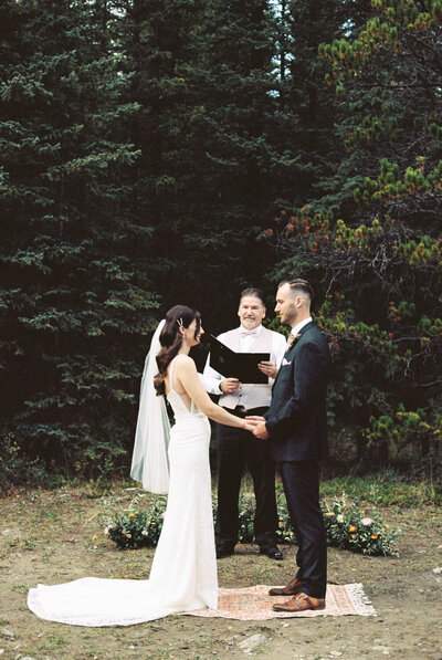 bride and groom at their ceremony in the forest