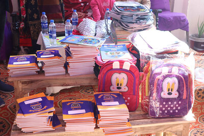 Close up view of the various school supplies, books, backpacks, waters, etc donated to the students of the school.