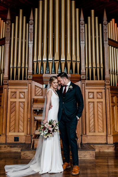 bride and groom posing at wedding venue