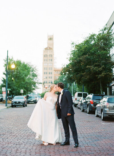 Bride and Groom Kissing on Brick Street in Asheville North Carolina Photo