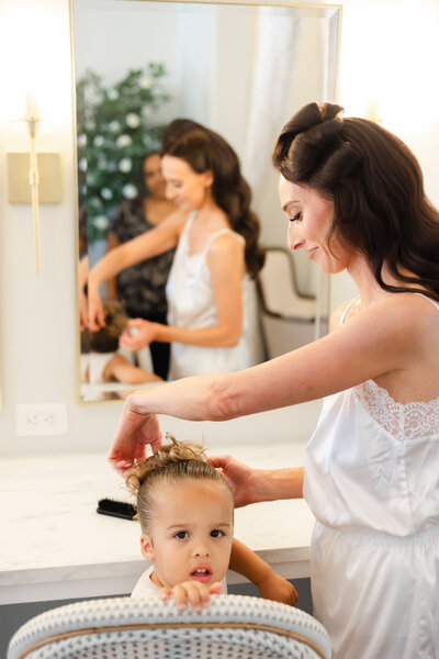 Bella Vista Farms Wedding - Bride fixing flower girl's hair