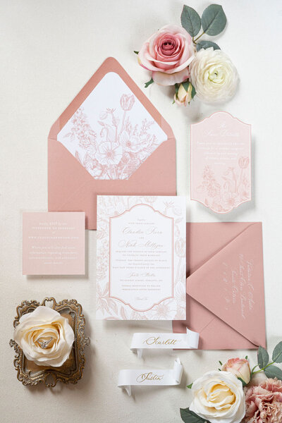 a pink and white wedding suite with flowers