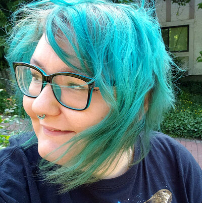 An image of Alyshia, facing away from the camera with a smile
