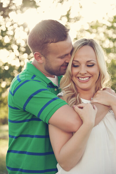 man hugging his bride to be during engagement photo session in Winter Garden