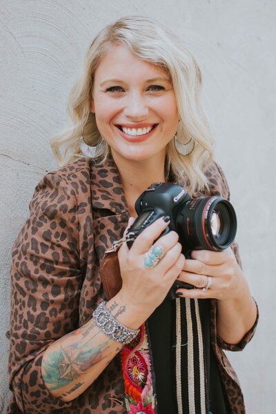 woman smiling and holding camera