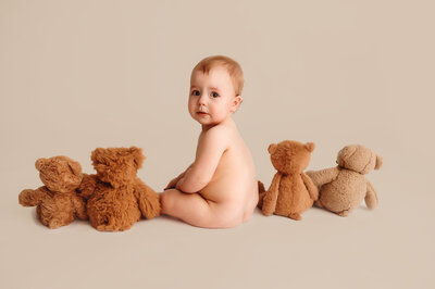 Baby peers at the camera during Milestone Photoshoot in Charleston, South Carolina Baby Photography Studio.