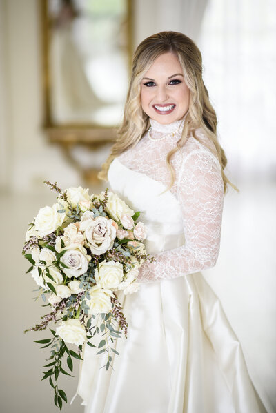 Beautiful Mississippi Wedding Photography: Bride leans from behind while column of old Mississippi farm house porch