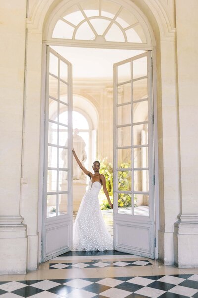 bride standing in the doorway in her bridal gown