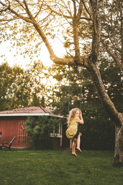 A little girl sitting in a tree in Ottawa