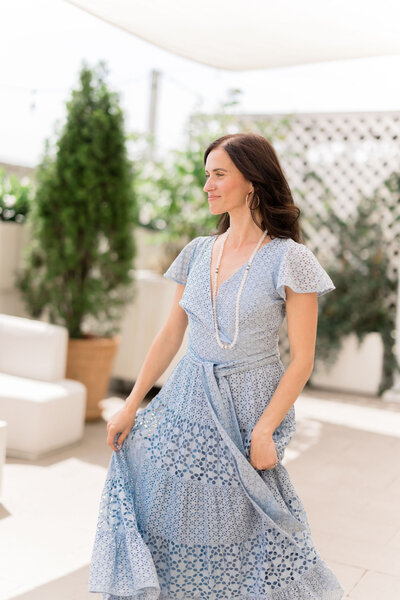 A woman looking beautiful in her long blue dress