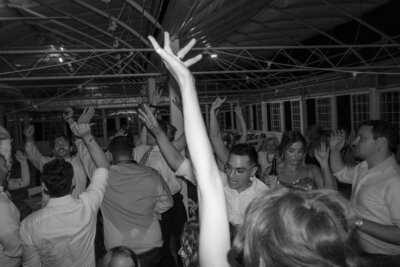 Wedding guest’s arm raised during the dancing at a wedding reception at Showalter’s Orchard in Harrisonburg, Virginia.