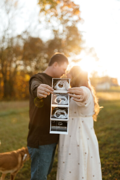 Brunette Pregnant Mother in a red dress with her hand on her stomach