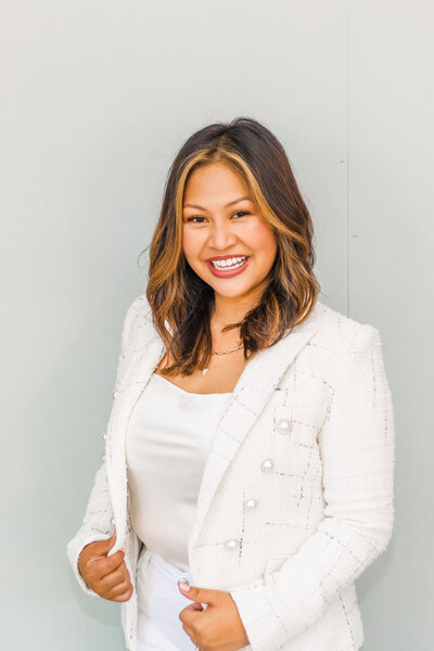 Smiling woman wearing white blazer