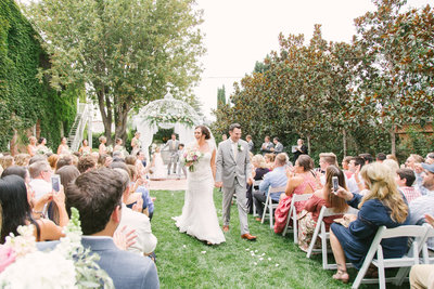 Bride and groom exit after wedding at 1880 Union Hotel