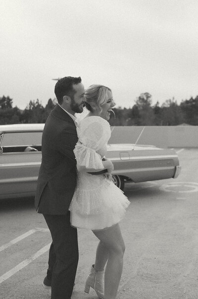 orange county elopement photo of bride and groom with vintage car