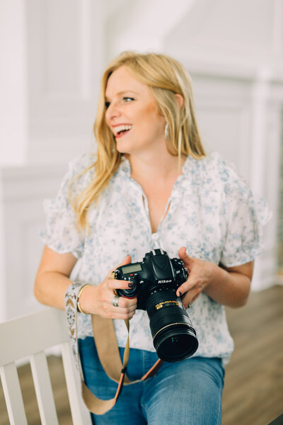 lpco photographer holding camera looking right and laughing